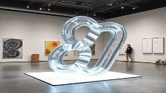 polycarbonate plastic sculpture, intriguing, being installed, photorealistic, modern art gallery with minimalist decor, highly detailed, gentle light reflections, ultra-high definition, vivid and sharp contrasts, soft diffused lighting, shot with a 35mm lens.